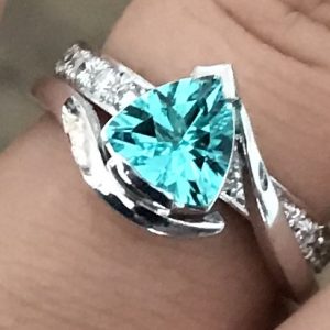 Paraiba Trilliant Cut Tourmaline & Diamond Ring finger view in natural daylight